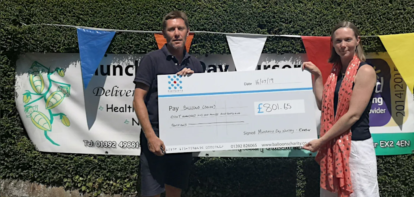 Giant novelty cheque held up at a fundraising event